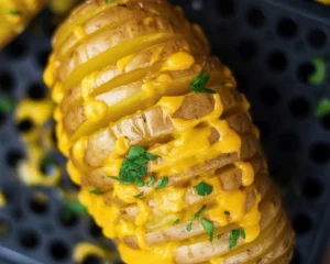 Delicious Cheesy Air Fryer Hasselback Potatoes topped with garlic and cheese.