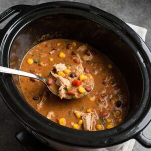 Creamy crockpot chicken chili with beans and corn.