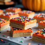 Halloween frosted sugar cookie bars topped with colorful icing and sprinkles