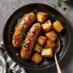 Plate of Honey Garlic Sausage served with roasted sweet potatoes