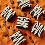 Spooky Mummy Brownies decorated with white icing and candy eyes