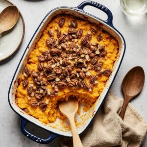Southern maple sweet potato casserole with pecan topping in baking dish