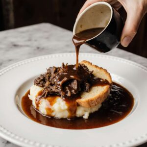 Beef Manhattan with toast, mashed potatoes, and rich gravy.