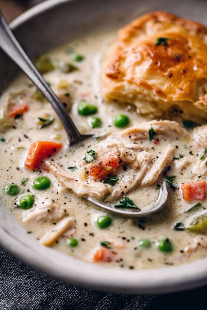 serving chicken pot pie soup on wooden table
