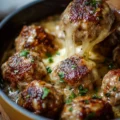 Delicious Cheesy French Onion Meatballs served with savory sauce and cheese