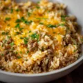 Cheesy ground beef and rice casserole served in a vibrant dish