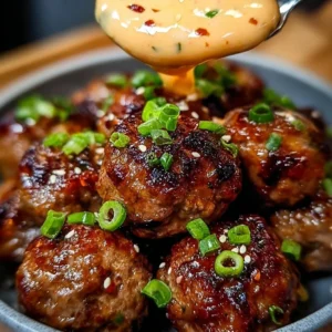Delicious Korean BBQ meatballs served with spicy mayo dip on a plate.