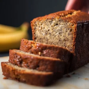 Freshly baked old fashioned banana bread on a wooden table