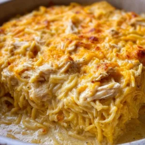 Creamy cheesy chicken spaghetti casserole served in a baking dish.