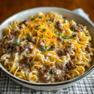 Delicious sour cream beef noodle casserole topped with cheese and herbs