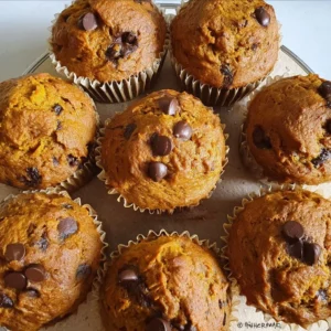 Freshly baked sourdough pumpkin muffins in a rustic kitchen setting.
