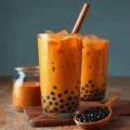 A refreshing glass of authentic Thai iced tea with boba and ice.