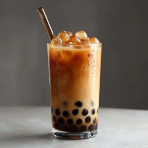 Brown Sugar Boba Iced Coffee with tapioca pearls and iced coffee in a glass