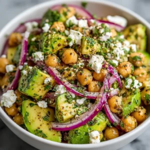 Chickpea feta avocado salad with fresh vegetables in a bowl