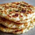 Delicious cottage cheese flatbread topped with fresh herbs and vegetables