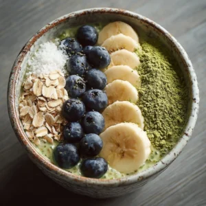 Bowl of matcha overnight oats topped with fruits and nuts for a nutritious breakfast