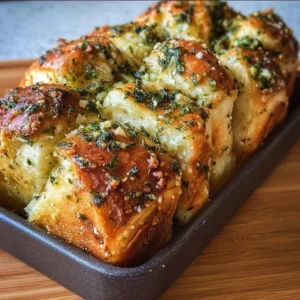 Delicious sourdough discard garlic pull apart bread served on a wooden board