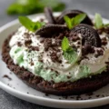 Delicious No-Bake Oreo Mint Pie topped with whipped cream and chocolate shavings