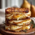 Pear and apple grilled cheese sandwich with melting cheese and fresh fruit slices