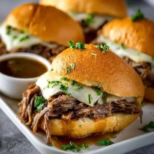 Delicious Crockpot French dip sandwiches served with dipping sauce