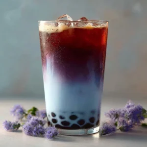 Strawberry Butterfly Pea Flower Boba Tea in a glass with vibrant colors