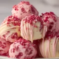 Delicious strawberry shortcake truffles on a white plate, garnished and ready to enjoy.