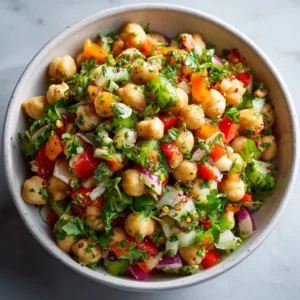 A vibrant chickpea salad featuring fresh vegetables and herbs for a healthy meal.