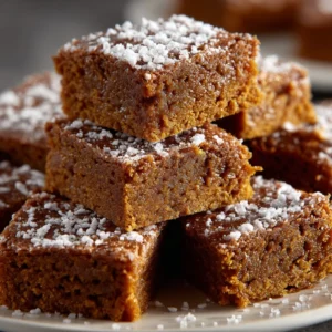 Delicious gingerbread bars topped with icing and spices, perfect for festive treats.