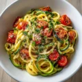 Healthy Tomato Zucchini Pasta served in a bowl with fresh basil and cheese