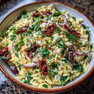 Homemade orzo pasta salad with feta cheese and sun-dried tomatoes