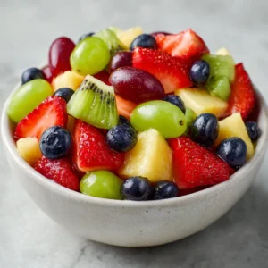 A vibrant bowl of fresh fruit salad with assorted seasonal fruits