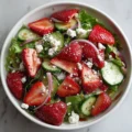 Fresh strawberry feta salad with greens and dressing for a quick meal