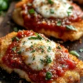 Crispy Parmesan Chicken served on a plate with herbs
