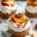 Peach Cobbler Cheesecake Bites served on a plate, showcasing delicious layers and toppings.