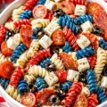 Delicious Red, White and Blue Pasta Salad with colorful ingredients for summer events.
