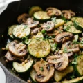 Sautéed skillet zucchini with mushrooms in a frying pan